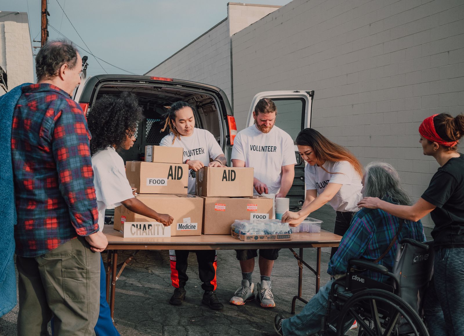Volunteers organizing aid packages for children and families for Supporting Children Through Community Organizations