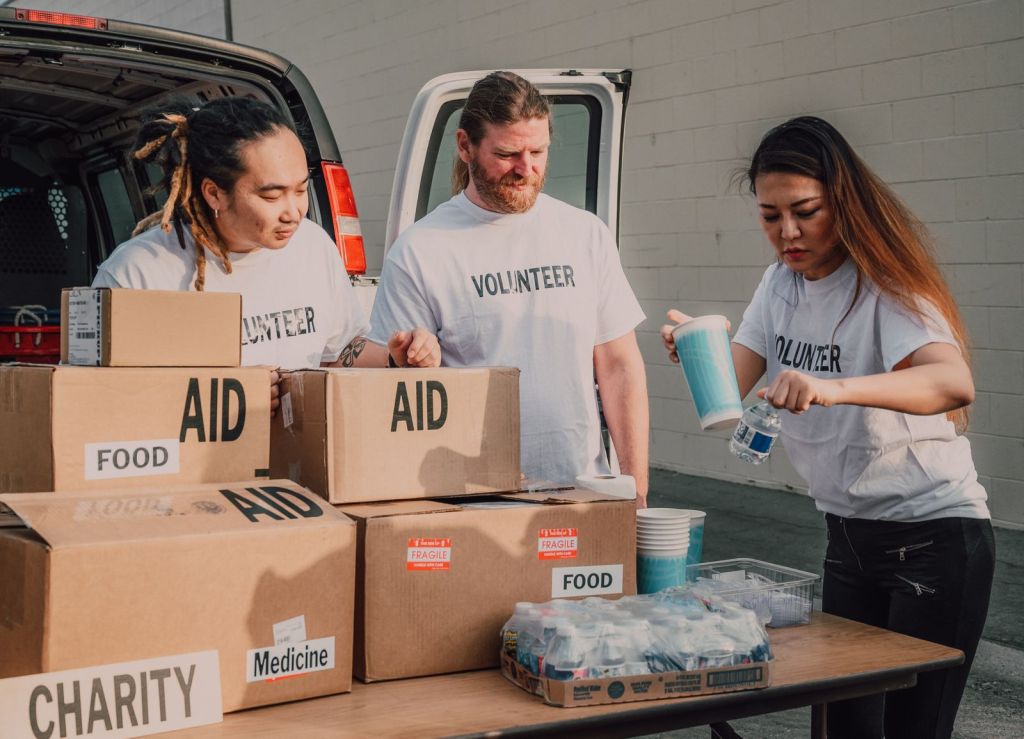 Volunteers sorting donations and food boxes for community aid for How Private Giving Supports Public Good in New York