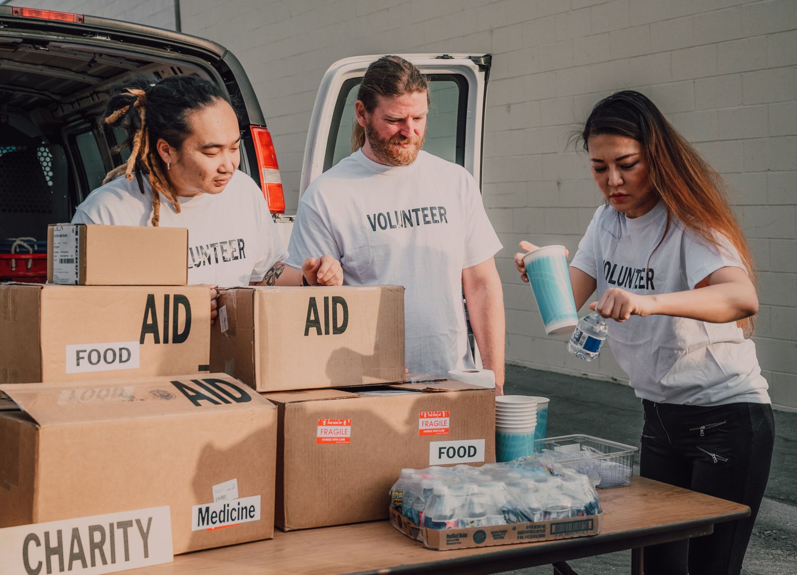 Volunteers sorting donations and food boxes for community aid for How Private Giving Supports Public Good in New York