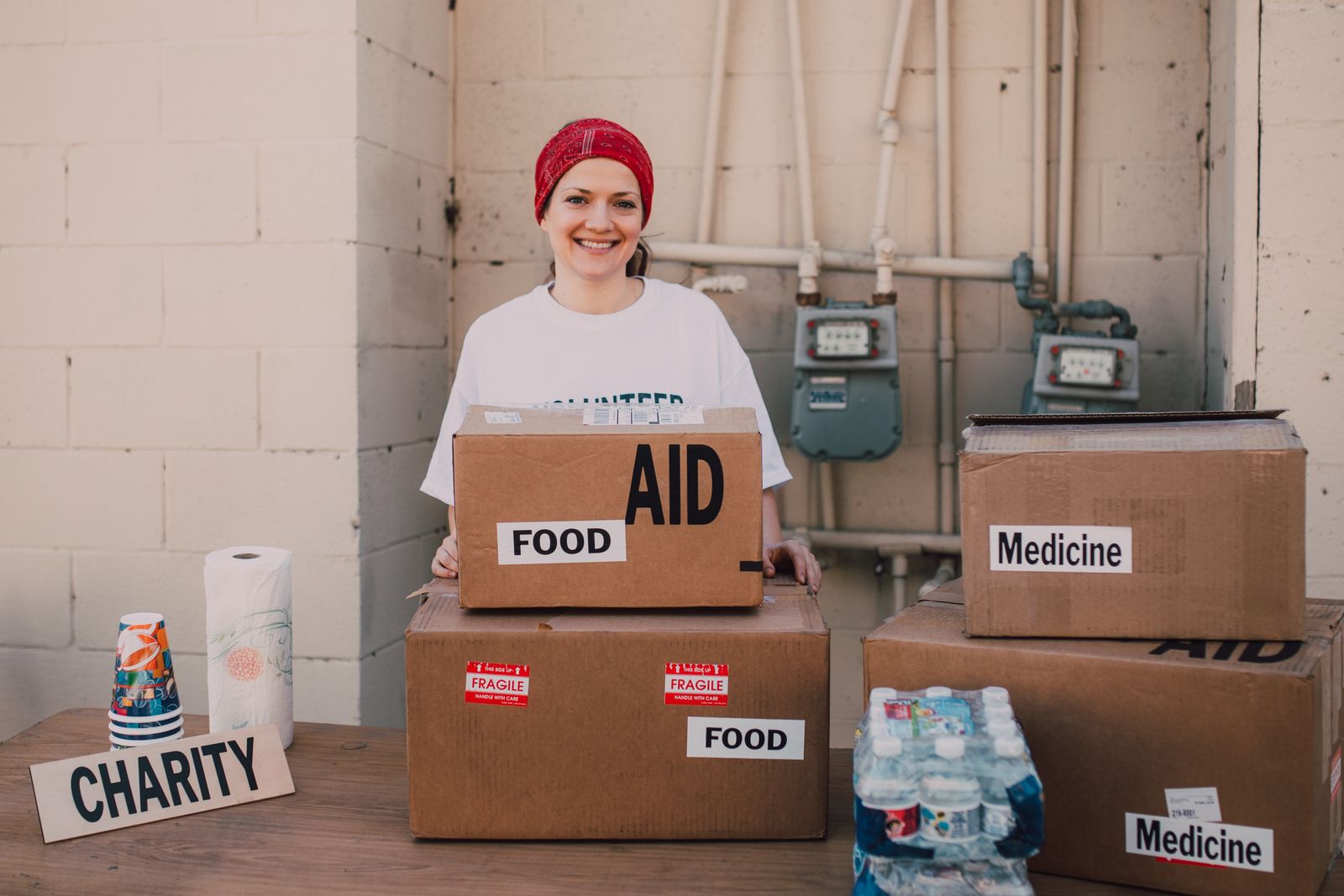 Volunteer handing out aid packages during charity work for Building Stronger Neighborhoods Through Volunteerism