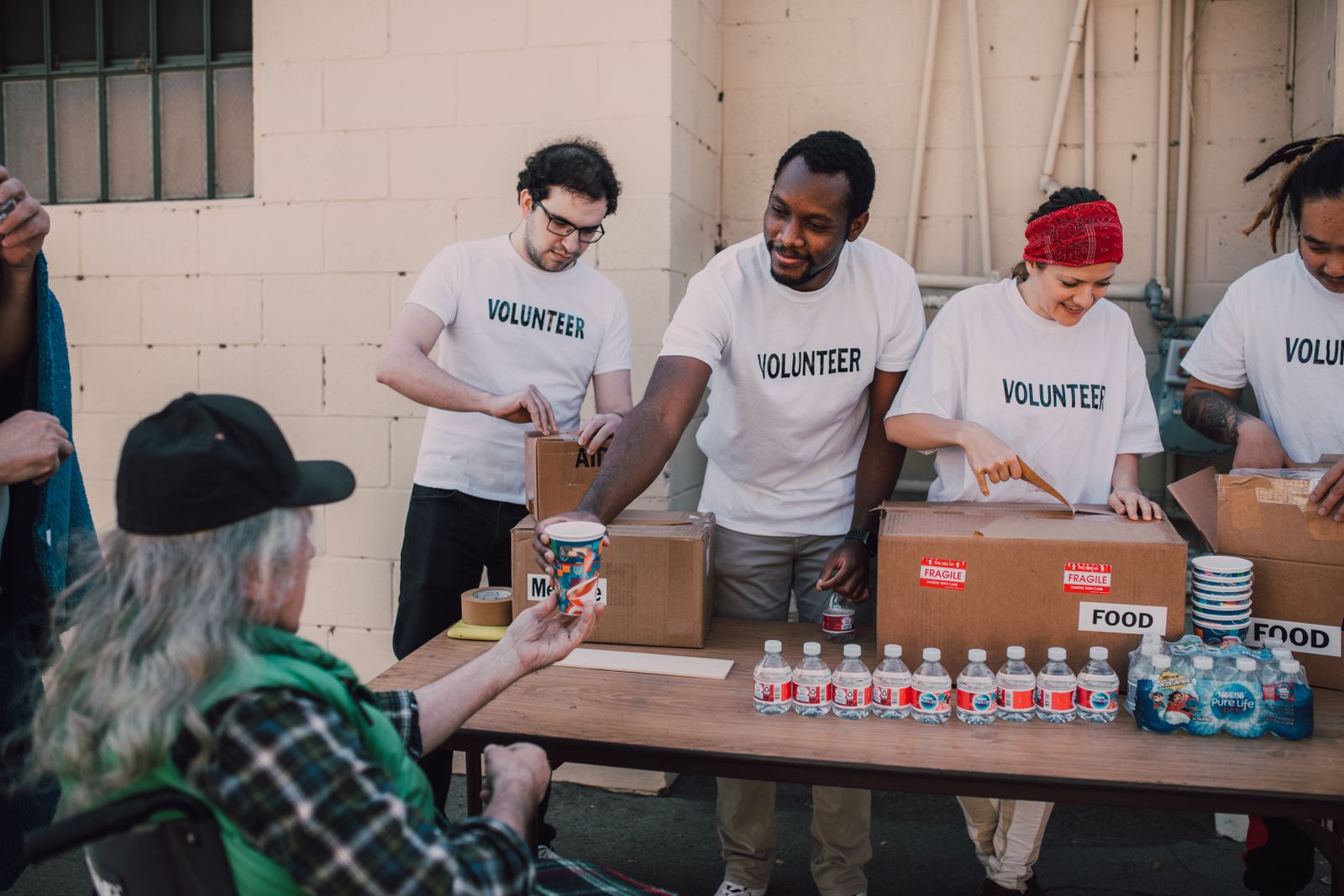 Volunteers distributing food and drinks for community food security for Why Food Security Continues to Matter in Brooklyn