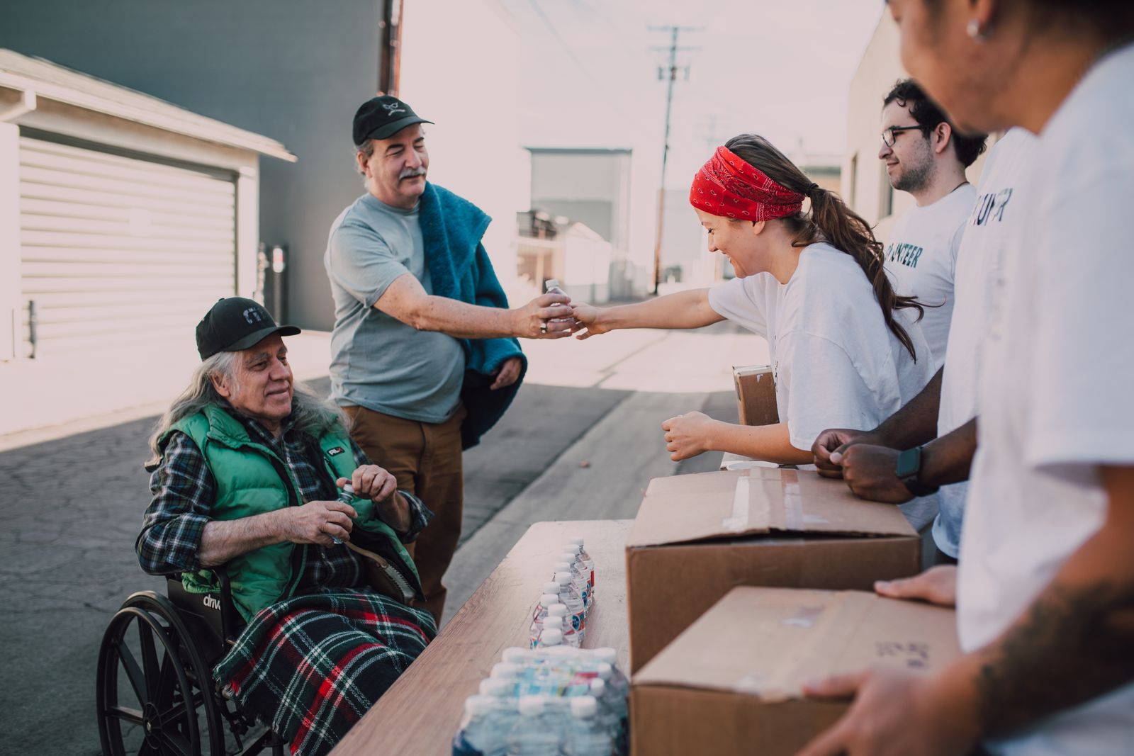 Volunteers distributing donations and supplies at a community aid event for Maksim Grinberg Supports Notes of Strength With a $500 Donation